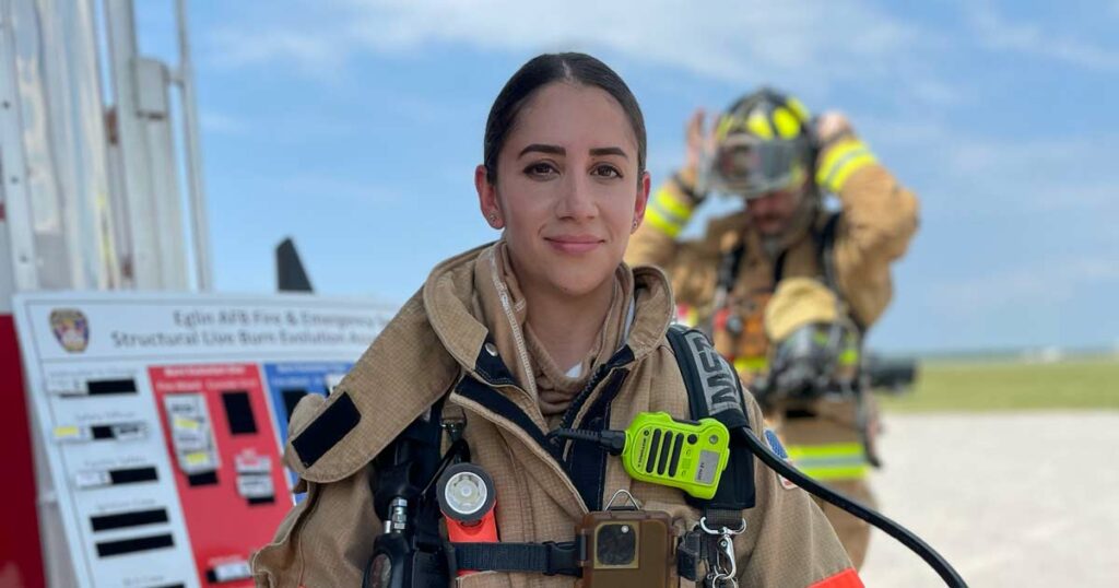 Image of a woman in a fire service uniform during training
